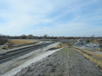 Matteston METRA station platform is in the middle of this picture. The bridge over the entrance to the Matteson METRA station is near the right edge of this photograph. A few cars in the Park Forest commuter parking lot can be seen on the right edge also.